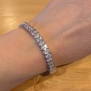 Silver colored tennis bracelet with cz marked 925 magnetic